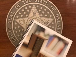 Image of dyslexia handbook with seal of Oklahoma in background